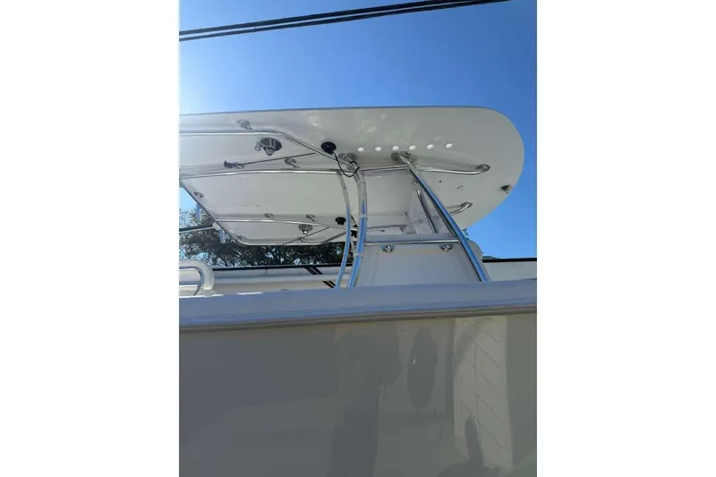 Slide: The Image of 2022 Contender 35 ST boat with sleek T-top design against clear blue sky. - 11