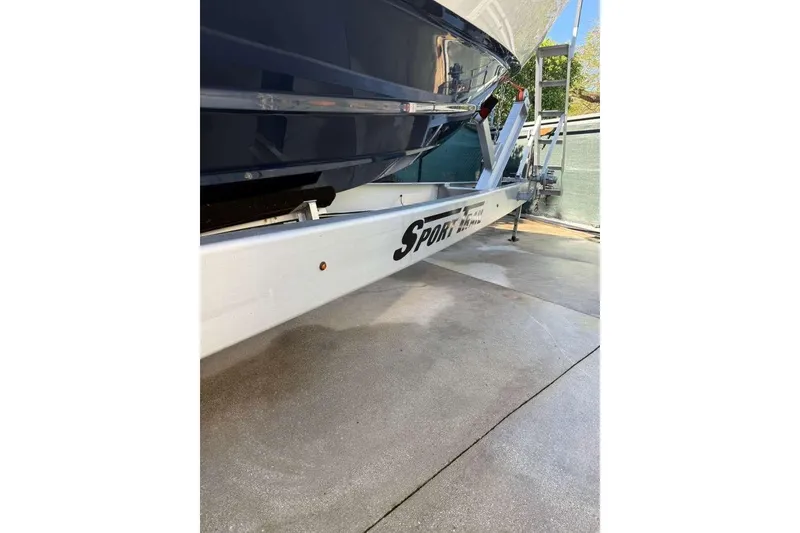 Slide: The Image of 2022 Contender 35 ST boat on Sport Trail trailer, parked on concrete. - 21