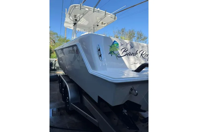 Slide: The Image of 2022 Contender 35 ST boat on trailer, featuring custom graphics and sleek design. - 23