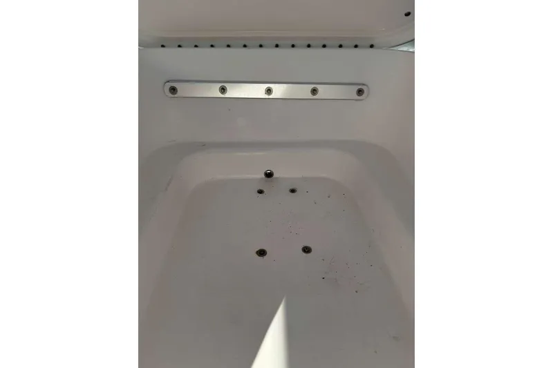 Slide: The Image of Contender 35 ST 2022 boat storage compartment with drainage holes. - 37