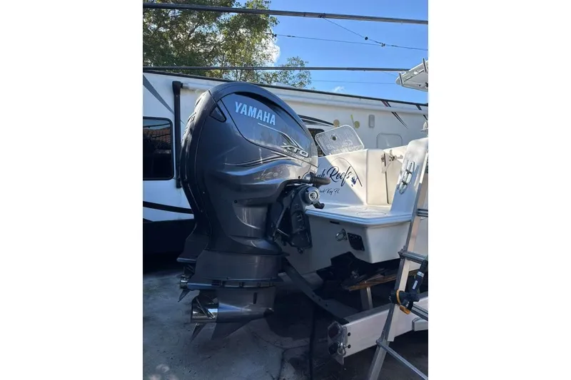 Slide: The Image of 2022 Contender 35 ST boat with Yamaha outboard motor, parked near a trailer. - 4