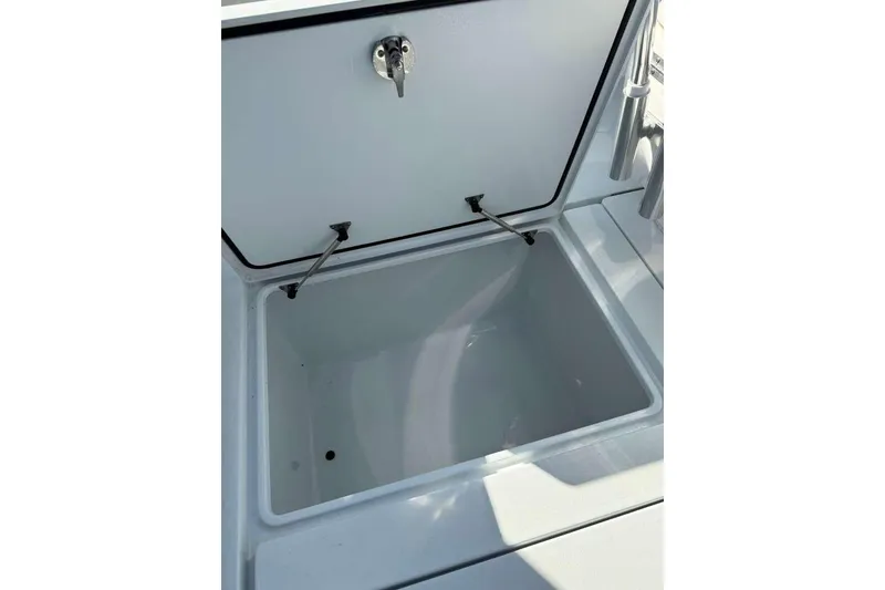 Slide: The Image of Open storage compartment on 2022 Contender 35 ST boat, featuring a secure latch. - 46