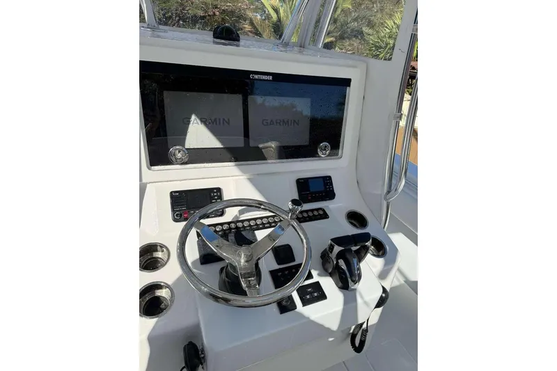 Slide: The Image of 2022 Contender 35 ST boat dashboard with Garmin navigation system and steering wheel. - 54