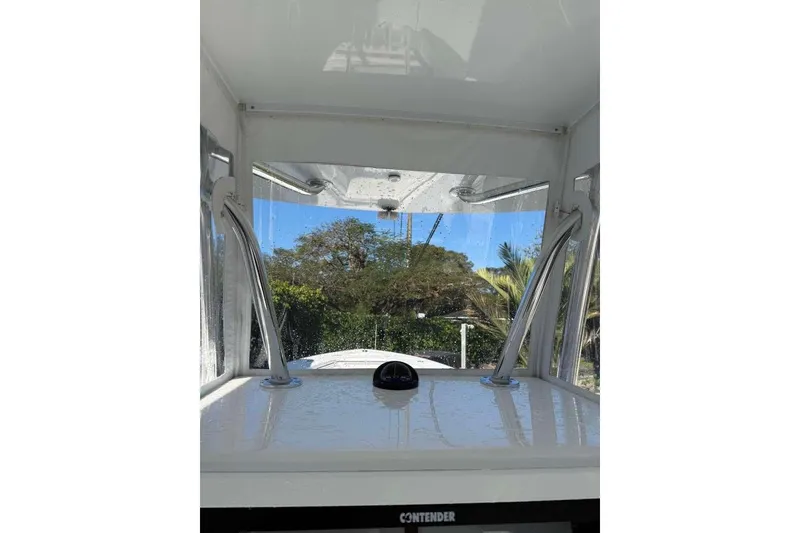 Slide: The Image of 2022 Contender 35 ST boat interior with clear windshield and scenic outdoor view. - 55