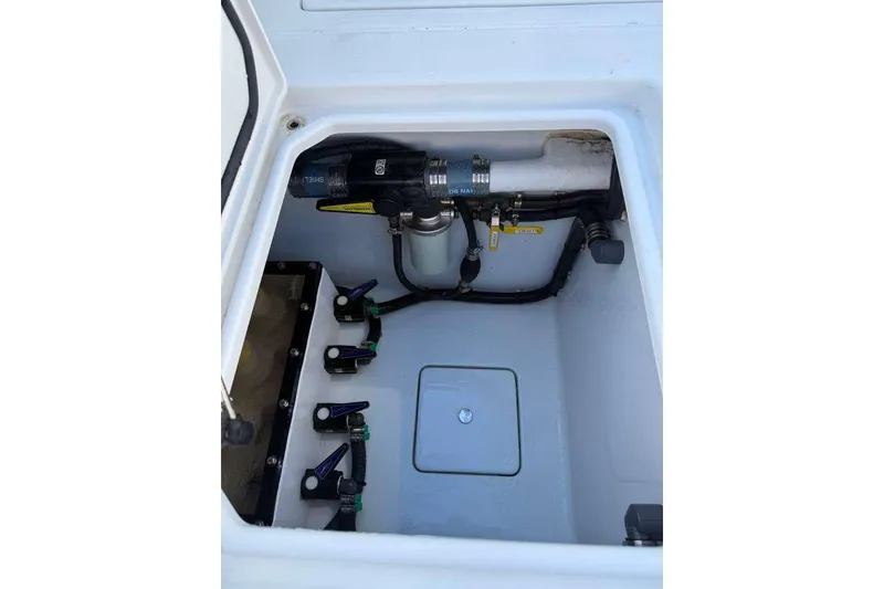 Slide: The Image of 2022 Contender 35 ST boat compartment with plumbing and valves. - 58
