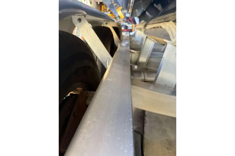 Slide: The Image of Close-up of a 2022 Contender 35 ST boat trailer, showcasing structural details. - 6