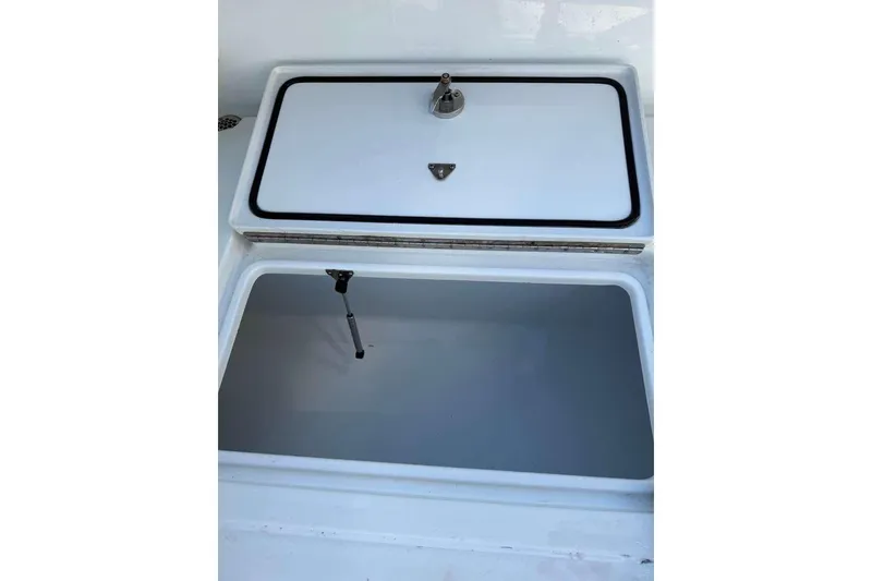 Slide: The Image of Open storage compartment on a 2022 Contender 35 ST boat. - 61