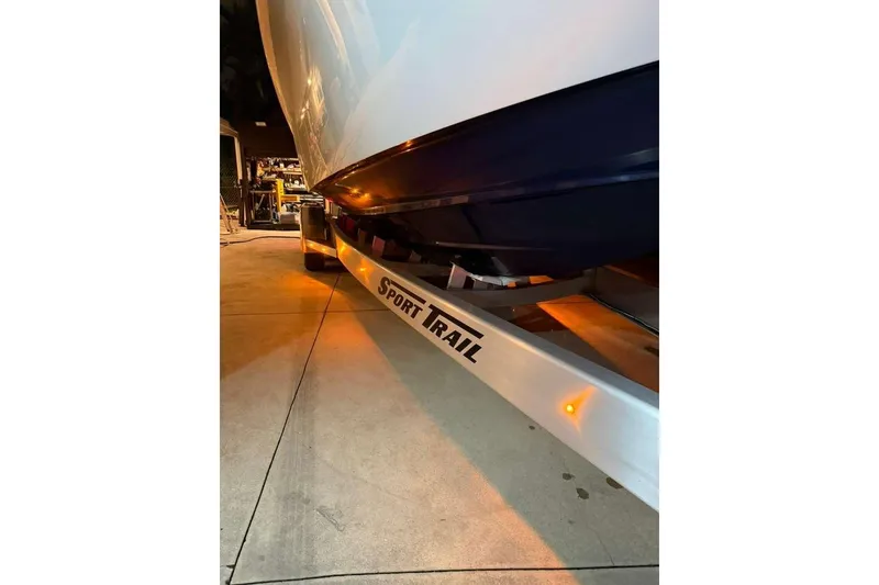 Slide: The Image of 2022 Contender 35 ST boat on Sport Trail trailer, illuminated in a garage setting. - 63