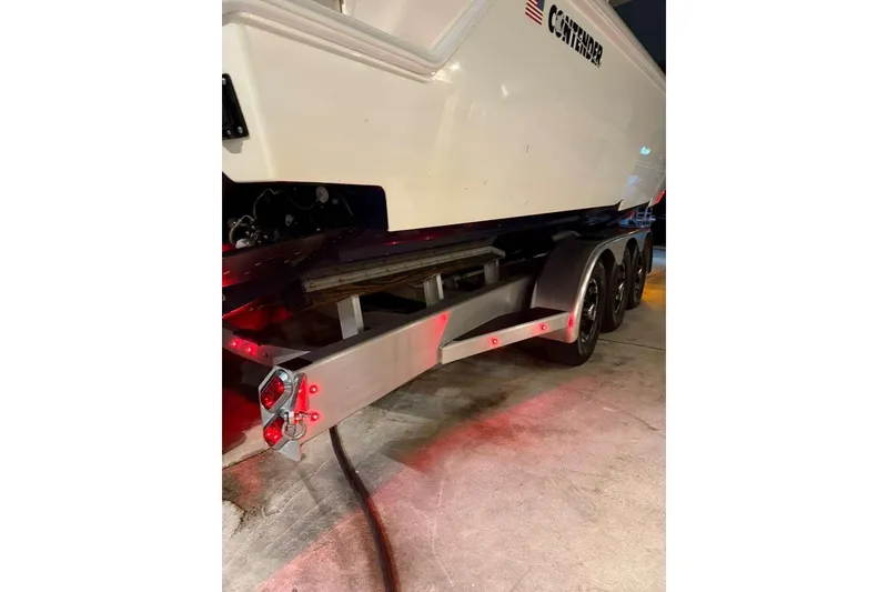 Slide: The Image of 2022 Contender 35 ST boat on trailer with illuminated red lights. - 64