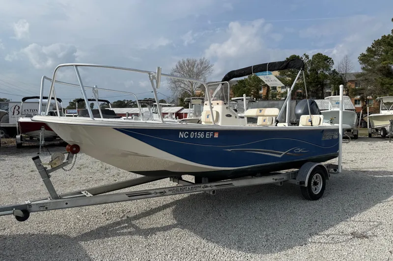 Slide: The Image of 2017 Carolina Skiff 218 DLV boat on trailer, parked outdoors. - 14