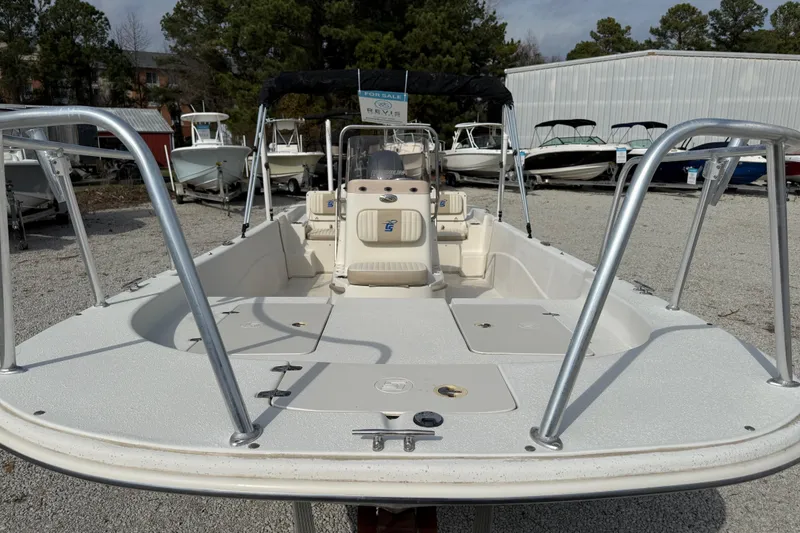 Slide: The Image of 2017 Carolina Skiff 218 DLV boat on display in a marina setting. - 16