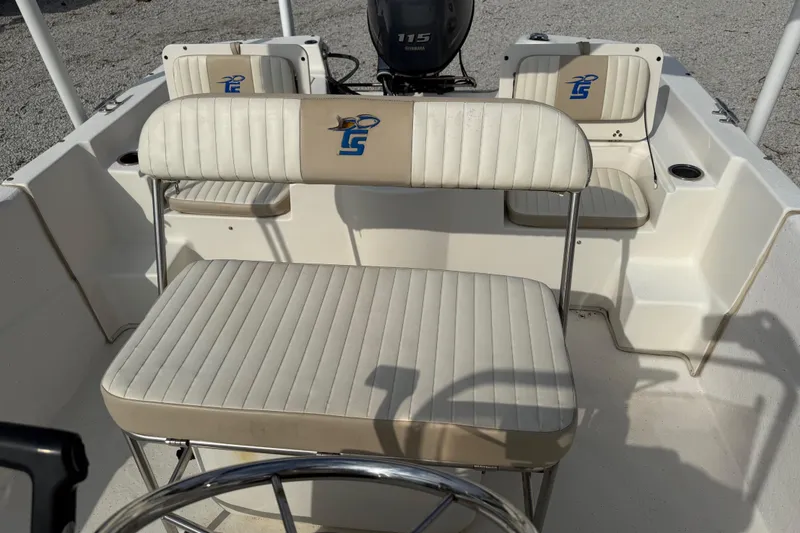 Slide: The Image of 2017 Carolina Skiff 218 DLV boat interior with seating and steering wheel. - 23