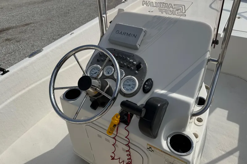 Slide: The Image of 2017 Carolina Skiff 218 DLV boat console with steering wheel and Garmin device. - 25
