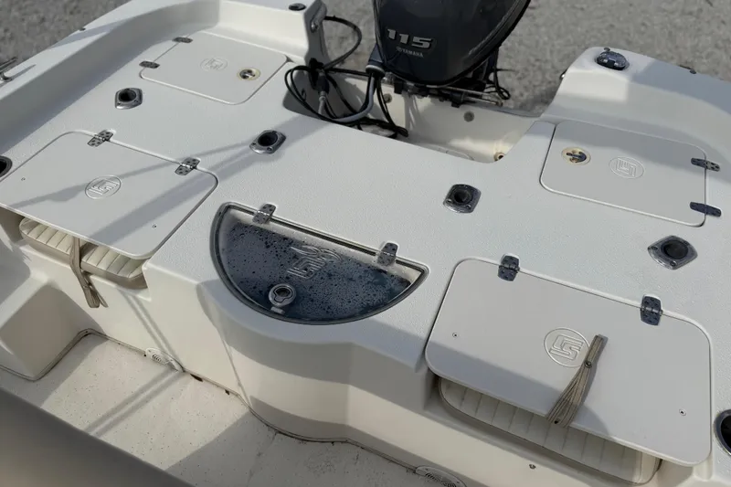 Slide: The Image of 2017 Carolina Skiff 218 DLV boat deck with storage compartments and Yamaha 115 engine. - 29
