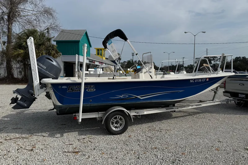 Slide: The Image of 2017 Carolina Skiff 218 DLV boat on trailer, parked outdoors. - 3