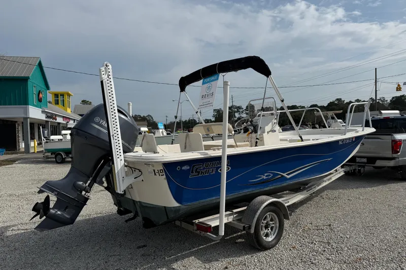 Slide: The Image of 2017 Carolina Skiff 218 DLV boat on trailer, parked outdoors. - 4