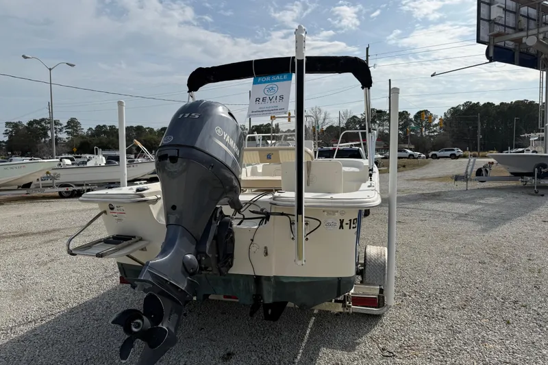 Slide: The Image of 2017 Carolina Skiff 218 DLV boat with Yamaha outboard motor, for sale in a gravel lot. - 6