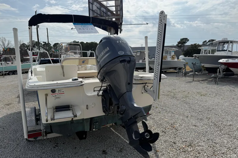 Slide: The Image of 2017 Carolina Skiff 218 DLV boat with Yamaha outboard motor in a dealership lot. - 8