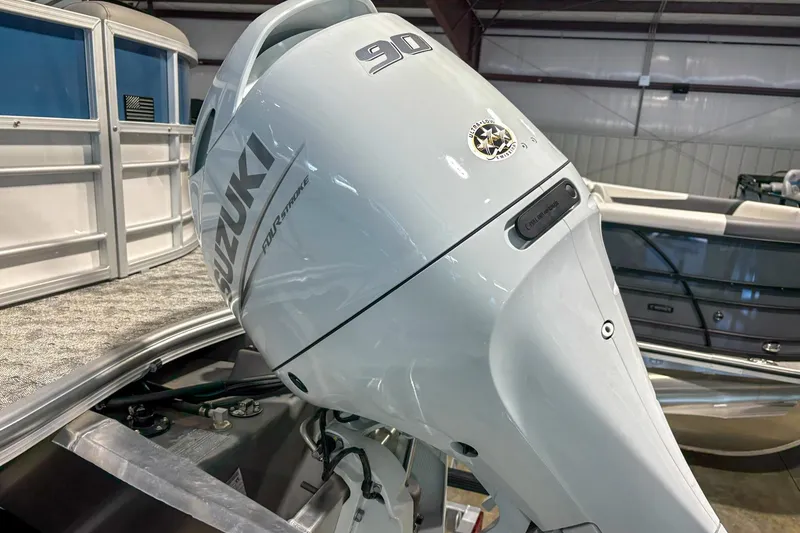 Slide: The Image of 2025 Trifecta 20RF LE with Suzuki 90 outboard motor in a showroom. - 11
