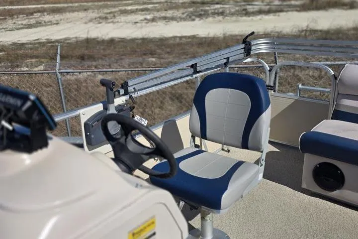 Slide: The Image of 2011 Weeres Cadet Fish 160 pontoon boat interior with steering wheel and seating. - 12