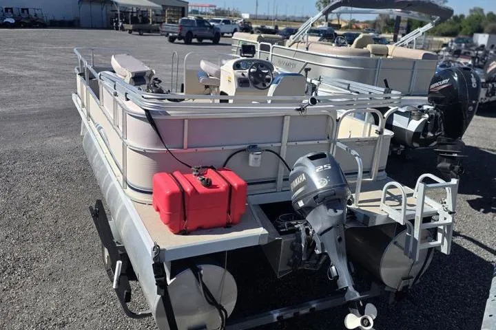 Slide: The Image of 2011 Weeres Cadet Fish 160 pontoon boat with Yamaha 25HP motor, parked on gravel. - 5