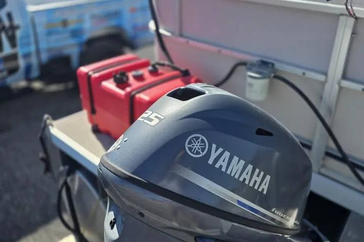 Slide: The Image of 2011 Weeres Cadet Fish 160 with Yamaha 25 outboard motor and red fuel tanks. - 6