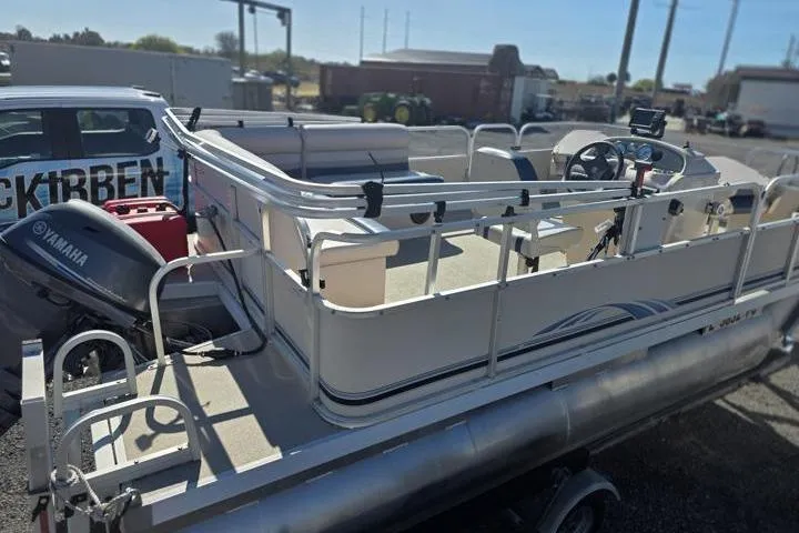 Slide: The Image of 2011 Weeres Cadet Fish 160 pontoon boat with Yamaha outboard motor in a parking lot. - 7