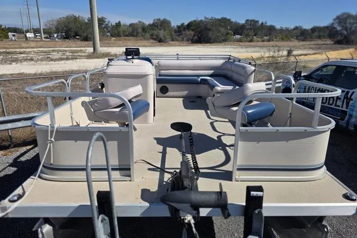 Slide: The Image of 2011 Weeres Cadet Fish 160 pontoon boat with seating, parked outdoors. - 9