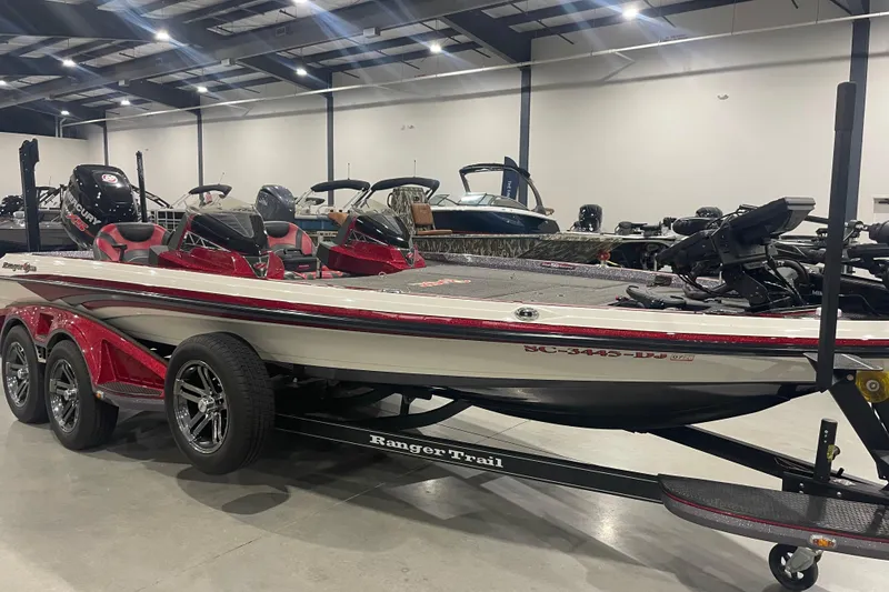 The Image of 2018 Ranger Z521L boat in showroom, featuring sleek design and triple-axle trailer. - 0