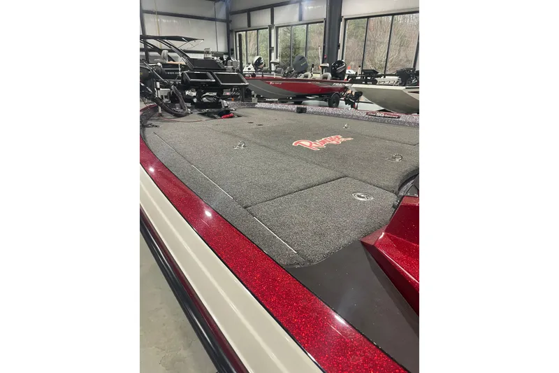 Slide: The Image of 2018 Ranger Z521L boat with red accents in a showroom setting. - 13