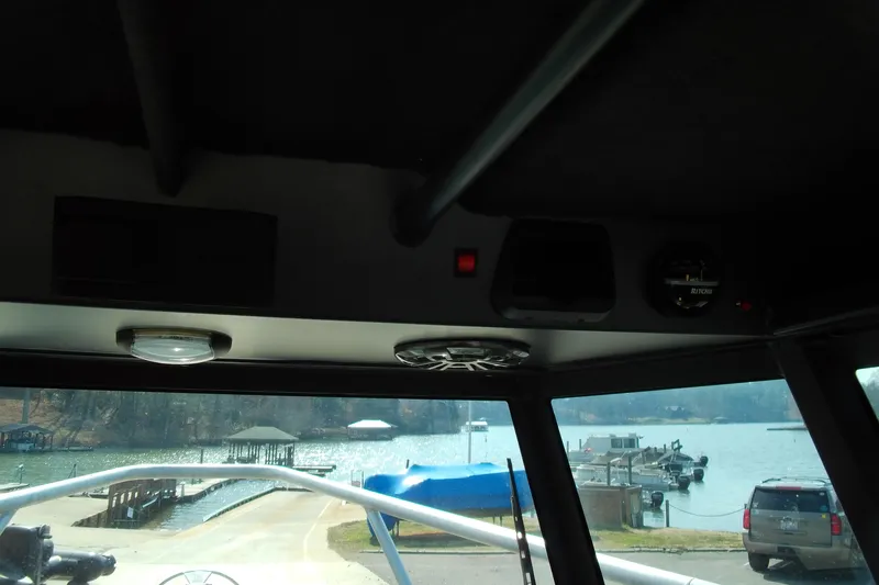 Slide: The Image of Interior view from a 2025 Stabicraft 2250 Ultra Centrecab, overlooking a marina. - 10