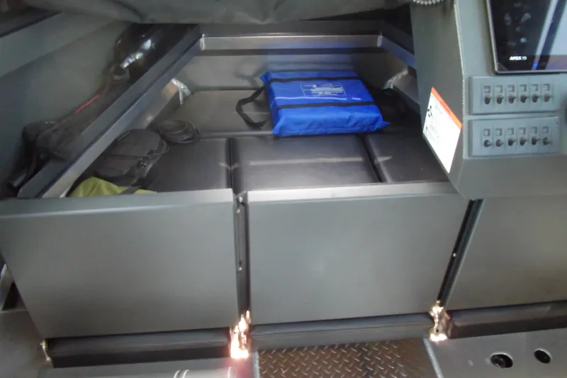 Slide: The Image of 2025 Stabicraft 2250 Ultra Centrecab interior storage with equipment and blue bag. - 12
