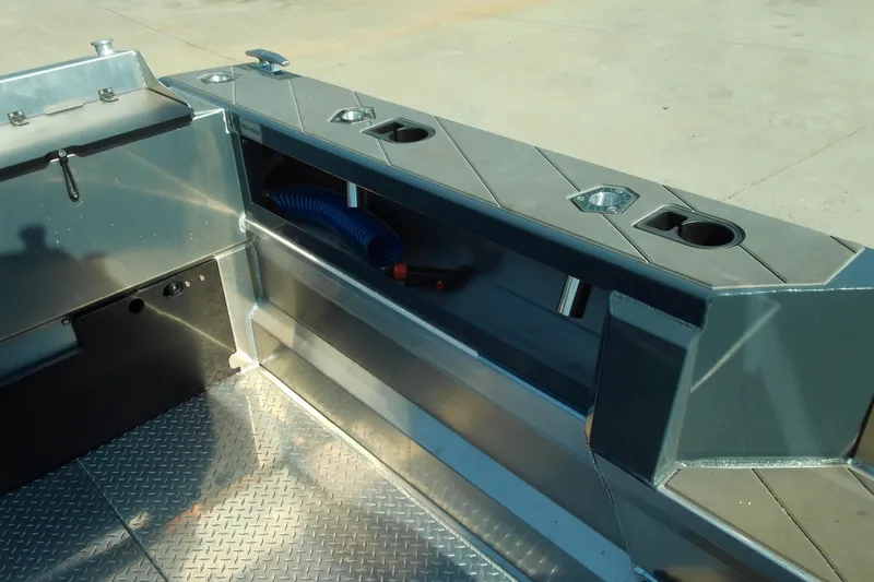 Slide: The Image of Interior view of 2025 Stabicraft 2250 Ultra Centrecab boat, featuring storage and cup holders. - 16