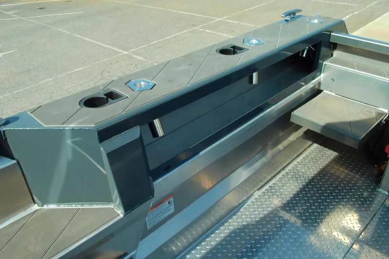 Slide: The Image of 2025 Stabicraft 2250 Ultra Centrecab interior with rod holders and diamond plate flooring. - 17