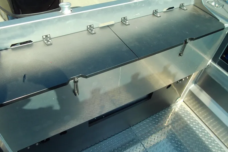 Slide: The Image of 2025 Stabicraft 2250 Ultra Centrecab interior with metal storage compartment and diamond plate flooring. - 25