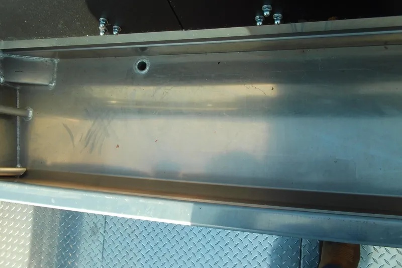 Slide: The Image of Interior view of 2025 Stabicraft 2250 Ultra Centrecab, showcasing metal compartment details. - 26