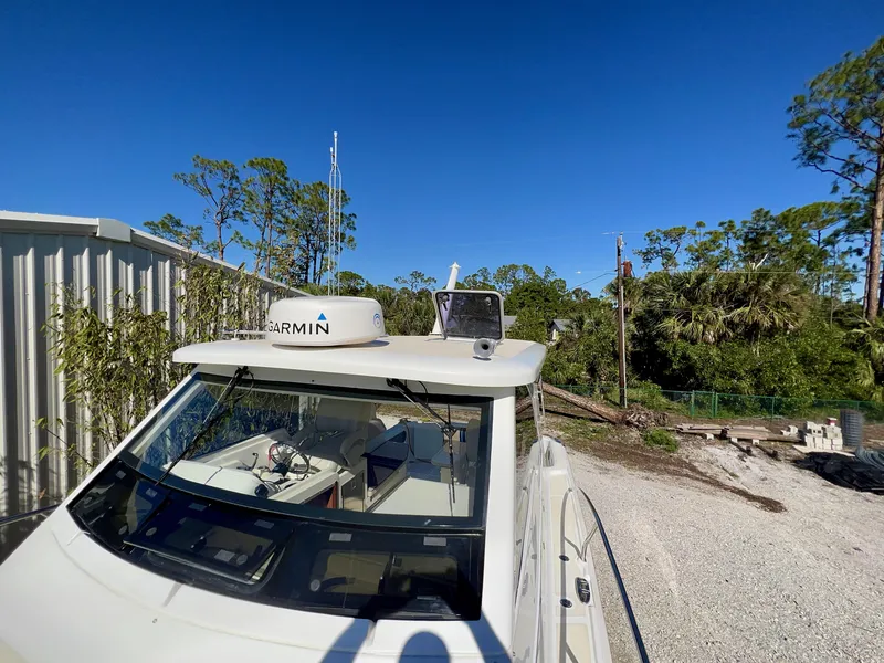 Slide: The Image of Marlow Pilot 31 boat, 2016 model, docked outdoors under clear blue sky. - 10