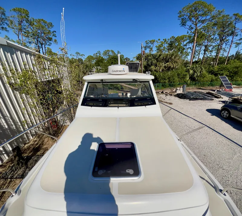 Slide: The Image of 2016 Marlow Pilot 31 boat on land, surrounded by trees and vehicles. - 13