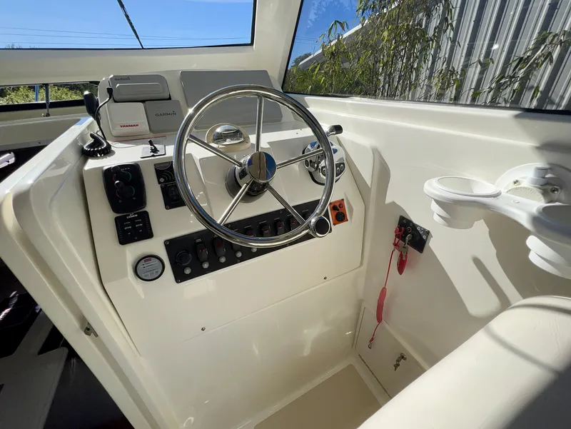 Slide: The Image of Helm of 2016 Marlow Pilot 31, featuring steering wheel and control panel. - 16