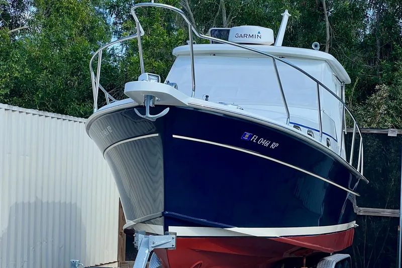 Slide: The Image of 2016 Marlow Pilot 31 boat with Garmin equipment, docked outdoors. - 2