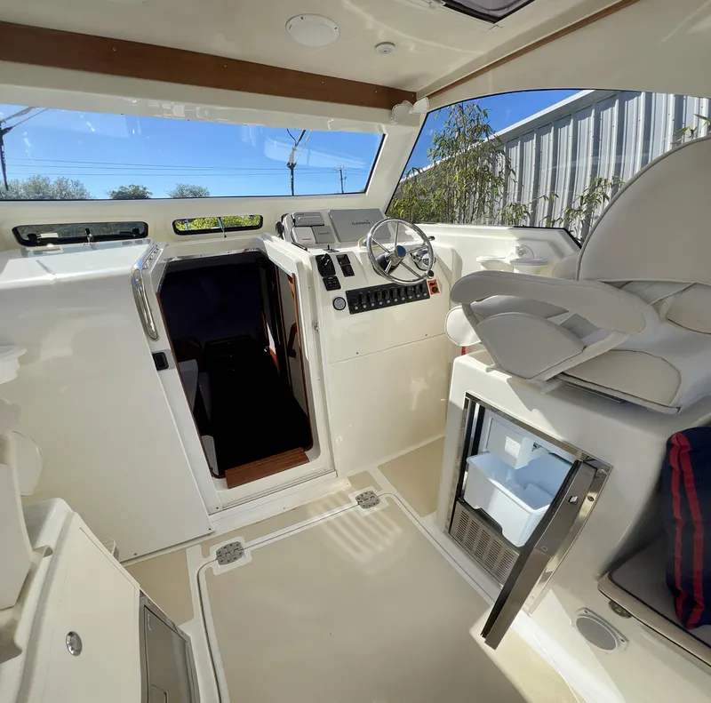Slide: The Image of Interior of 2016 Marlow Pilot 31, featuring helm and seating area. - 21