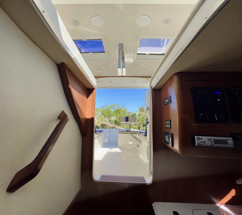 Slide: The Image of Interior view of 2016 Marlow Pilot 31 Pilot boat, featuring cabin entrance and control panel. - 24