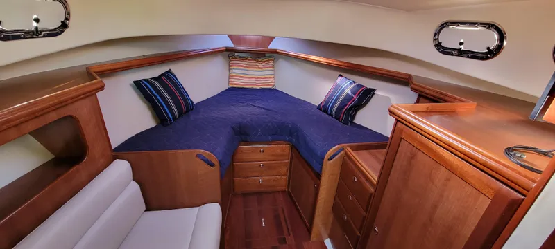 Slide: The Image of Cozy cabin interior of 2016 Marlow Pilot 31 with wood finish and blue bedding. - 35