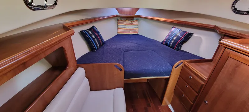 Slide: The Image of Cozy cabin interior of 2016 Marlow Pilot 31 with wooden finish and blue bedding. - 36
