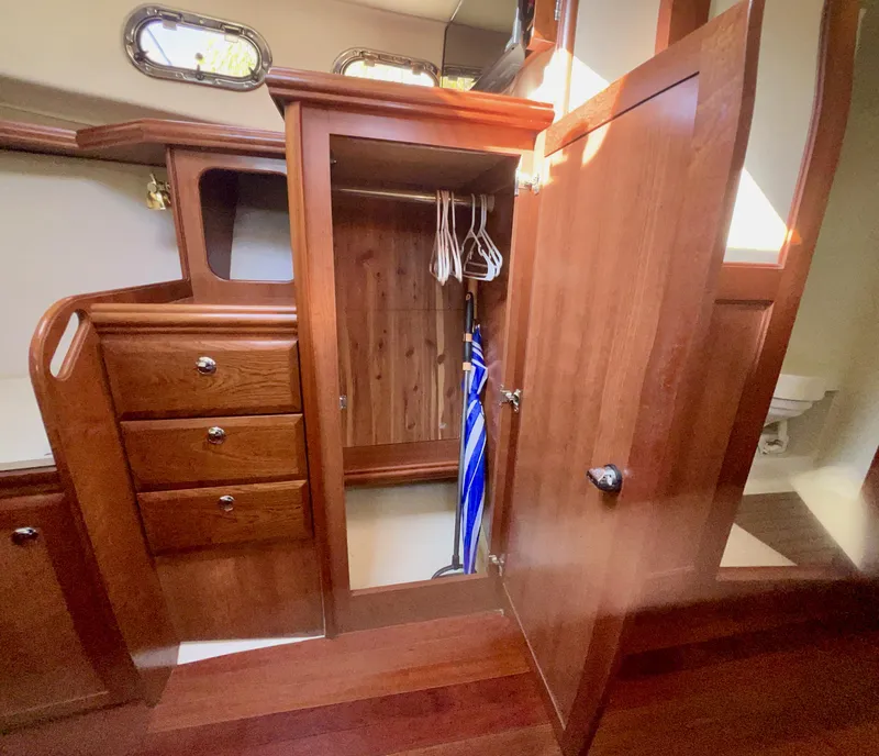 Slide: The Image of Wooden interior of 2016 Marlow Pilot 31 with open closet and drawers. - 37
