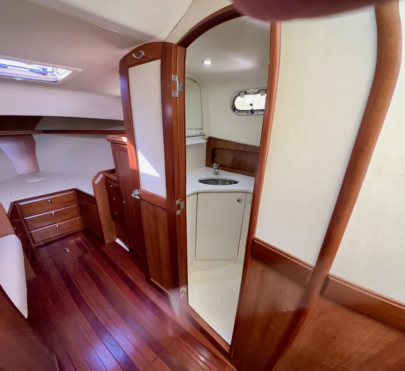 Slide: The Image of Interior of 2016 Marlow Pilot 31, featuring wood finish and compact bathroom. - 41