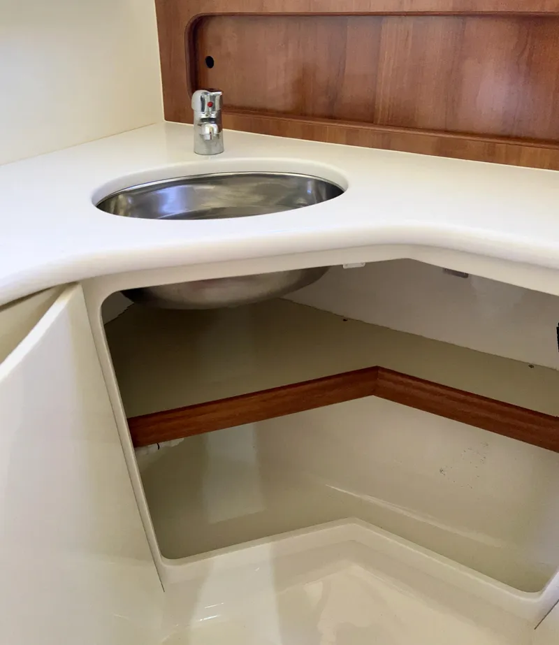 Slide: The Image of 2016 Marlow Pilot 31 boat interior sink with wooden accents. - 42