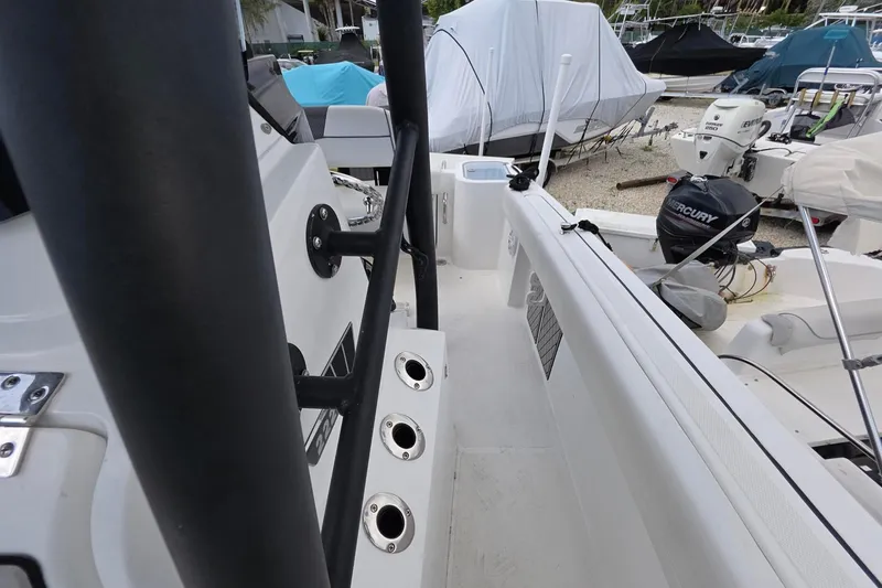 Slide: The Image of 2022 Wellcraft 222 Fisherman boat interior with rod holders and Mercury outboard motor. - 10