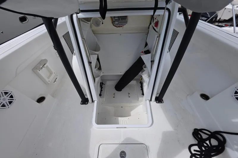Slide: The Image of 2022 Wellcraft 222 Fisherman boat interior with storage and seating area. - 13