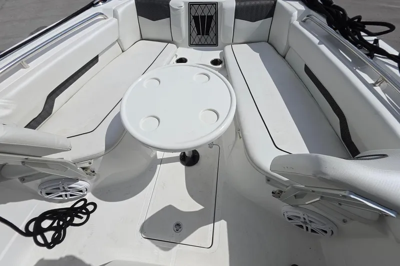 Slide: The Image of 2022 Wellcraft 222 Fisherman boat interior with seating and round table. - 14